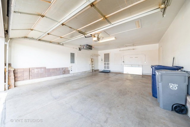 garage with electric panel and a garage door opener