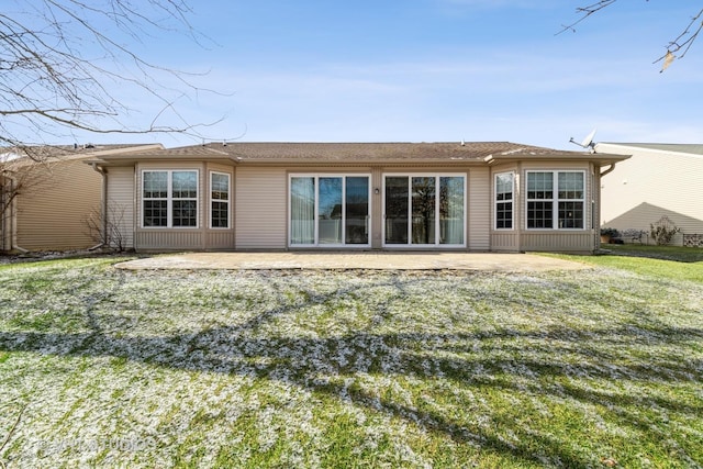 back of property featuring a patio area and a lawn