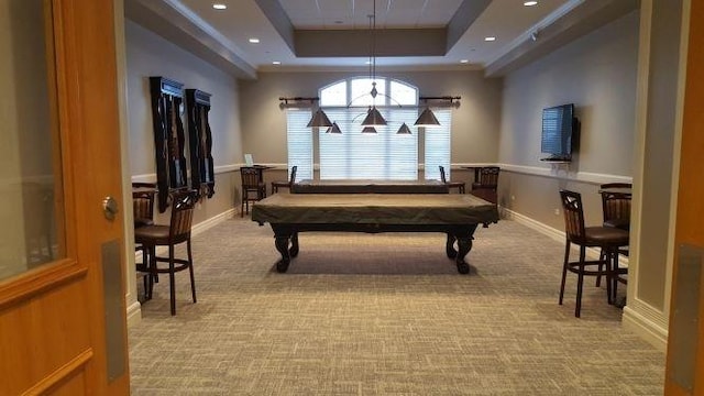 rec room with a raised ceiling, light colored carpet, and pool table