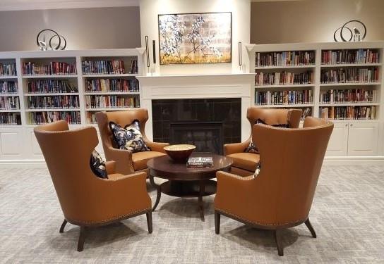 sitting room with a tiled fireplace and carpet floors