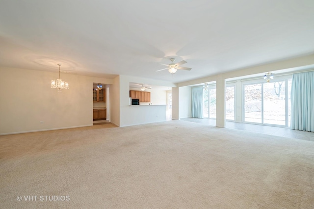 unfurnished living room featuring light colored carpet and ceiling fan with notable chandelier