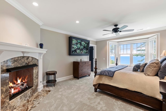 bedroom featuring ceiling fan, ornamental molding, and light colored carpet