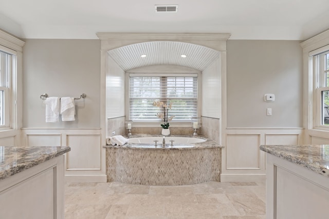 bathroom with vanity and a tub