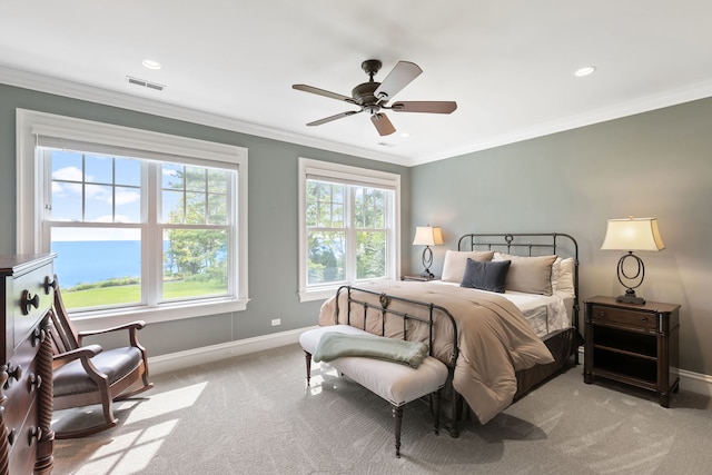 bedroom with light carpet, ceiling fan, and crown molding