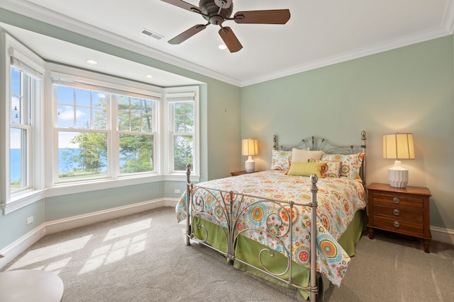 carpeted bedroom with ceiling fan, multiple windows, and crown molding