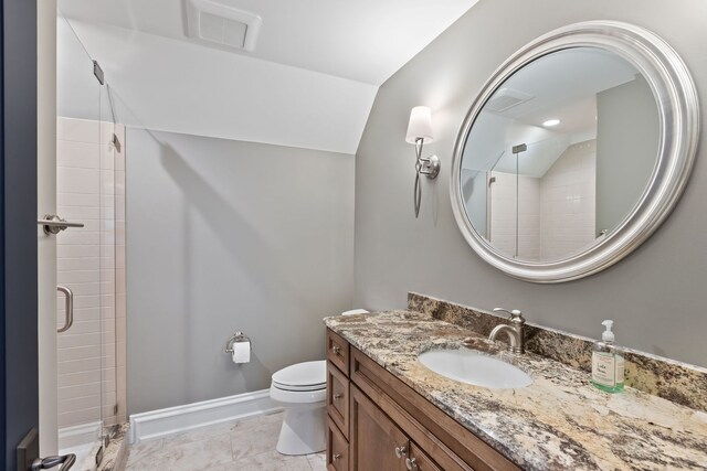 bathroom featuring toilet, vanity, vaulted ceiling, and a shower with door