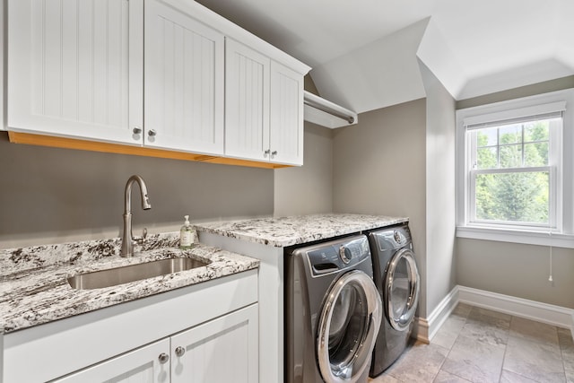 laundry area featuring cabinets, sink, and independent washer and dryer