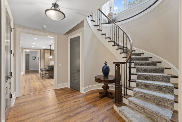 entryway with hardwood / wood-style floors