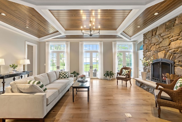 living room featuring wood ceiling, hardwood / wood-style floors, a fireplace, french doors, and crown molding