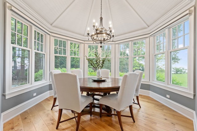 sunroom / solarium with lofted ceiling and a notable chandelier