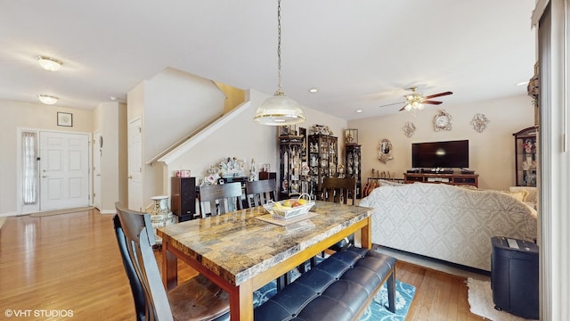 dining space with ceiling fan and wood-type flooring