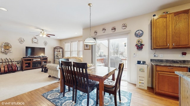 dining space featuring ceiling fan and light hardwood / wood-style flooring