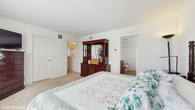 carpeted bedroom featuring ensuite bath