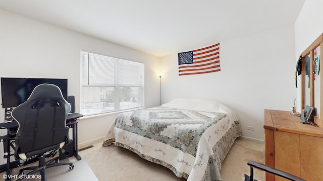 bedroom featuring light carpet