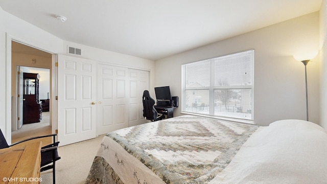 carpeted bedroom with a closet