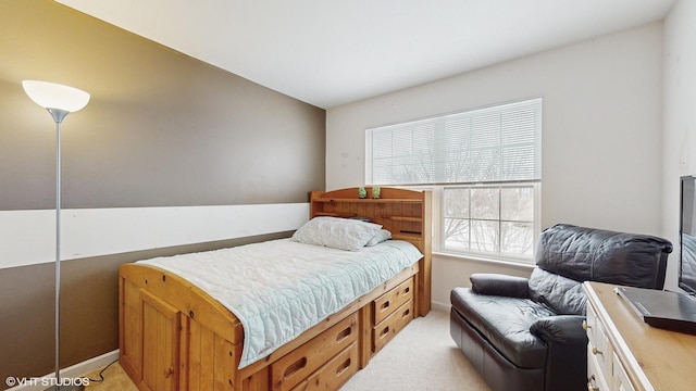 bedroom with light colored carpet and vaulted ceiling