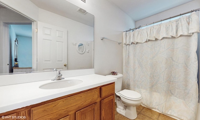 bathroom with tile patterned floors, walk in shower, vanity, and toilet