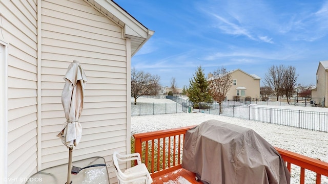 snow covered deck featuring grilling area