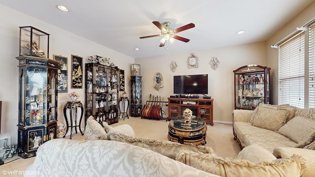 carpeted living room featuring ceiling fan