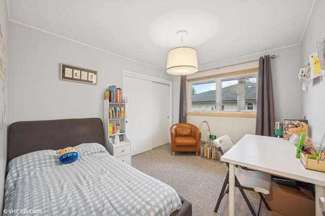 bedroom featuring carpet, ornamental molding, and a closet