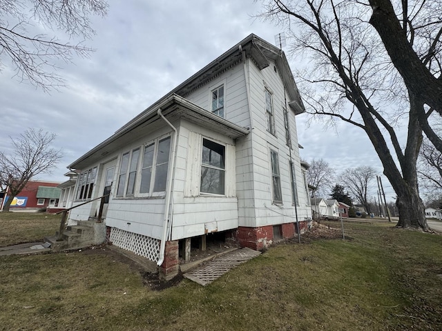 view of property exterior with a lawn