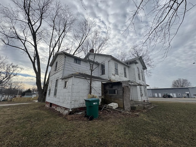 view of side of home with a lawn