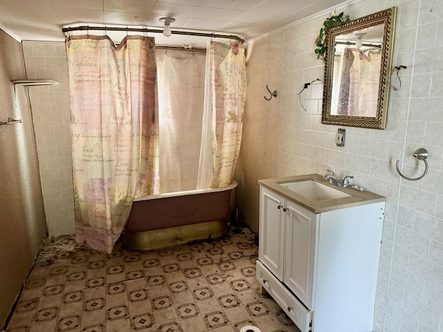 bathroom featuring shower / bath combo with shower curtain and vanity