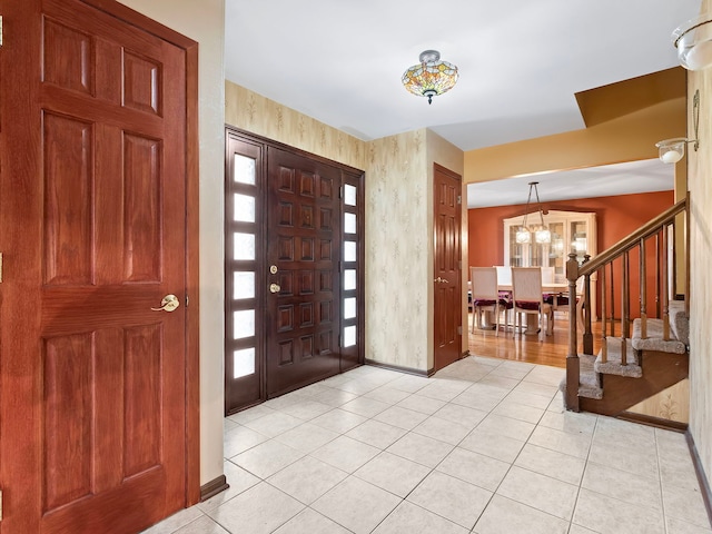 entryway featuring a notable chandelier and light tile patterned floors