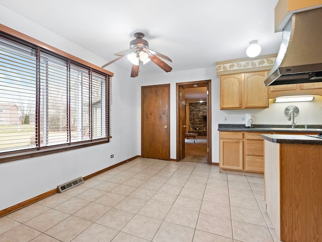 kitchen featuring ceiling fan, light brown cabinets, light tile patterned flooring, and extractor fan