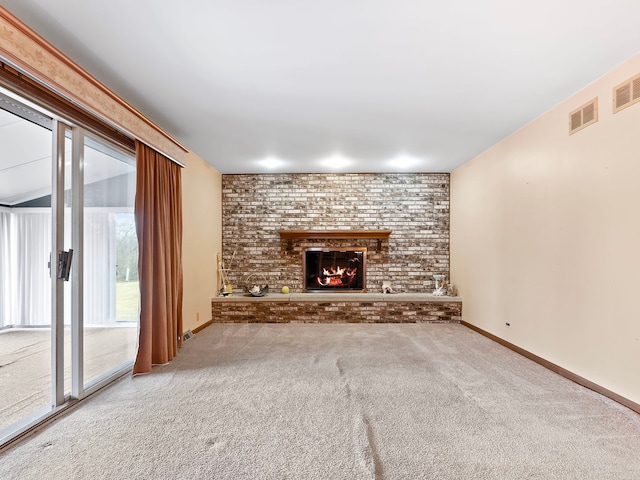 unfurnished living room with a fireplace and carpet flooring