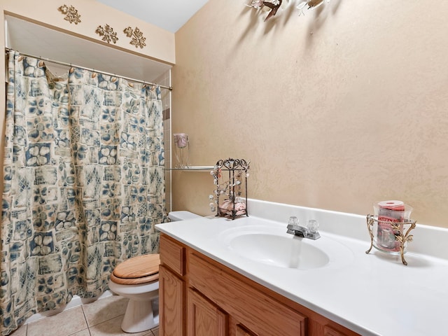 bathroom featuring tile patterned flooring, vanity, toilet, and curtained shower