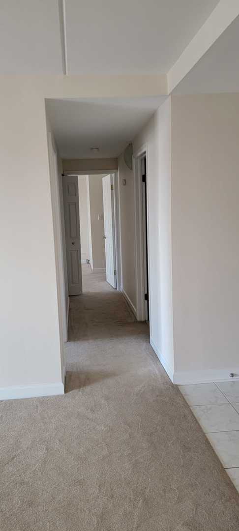 corridor with light colored carpet