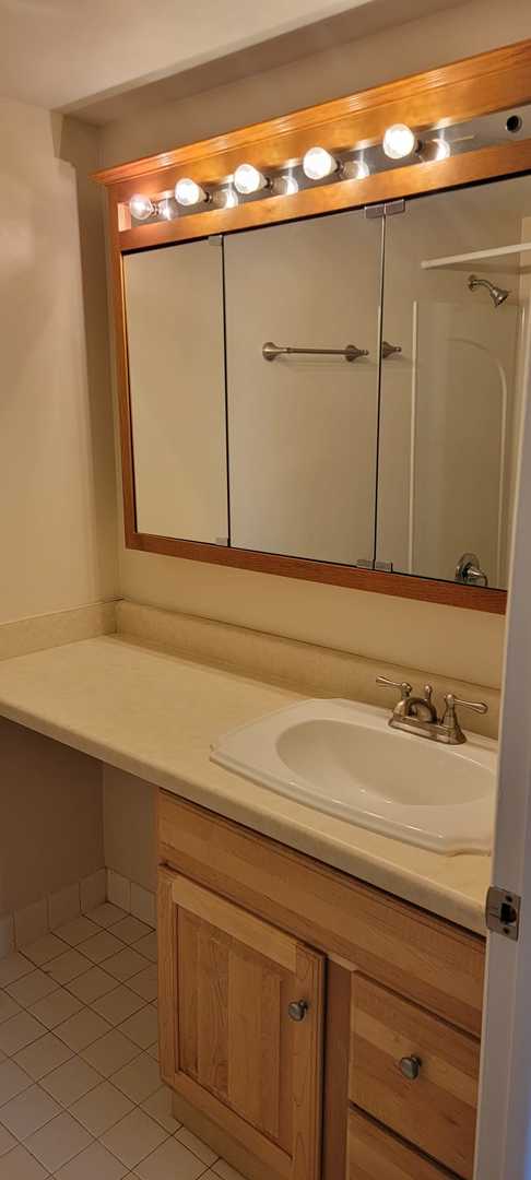 bathroom with tile patterned flooring and vanity