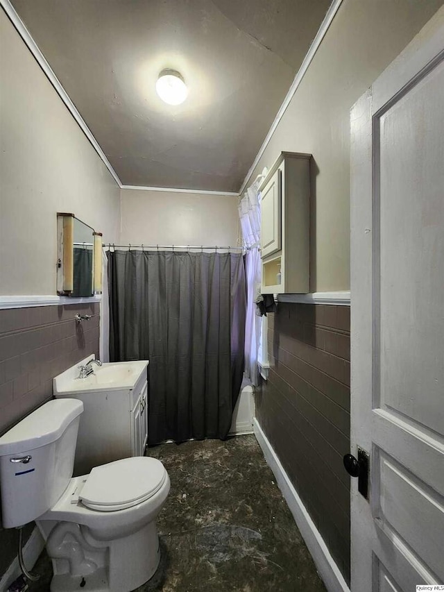 full bathroom with ornamental molding, vanity, toilet, and tile walls