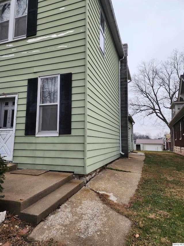 view of property exterior featuring a lawn