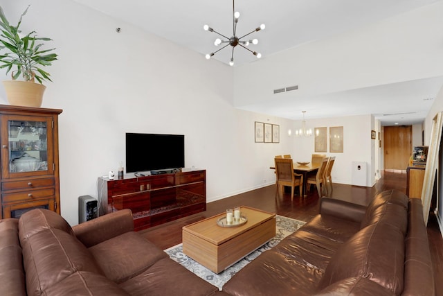 living room featuring a notable chandelier and dark hardwood / wood-style flooring