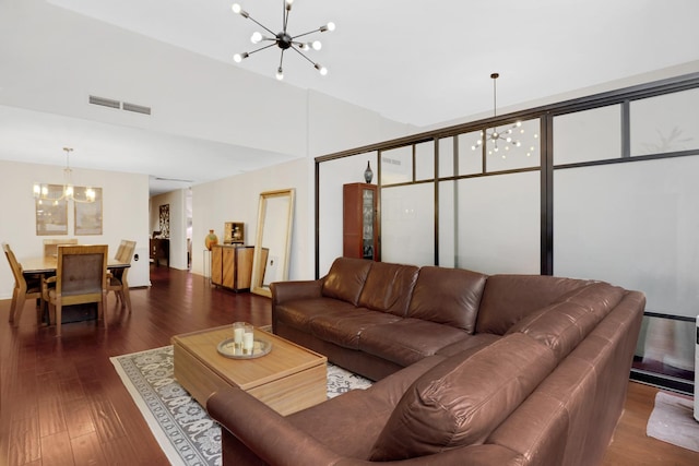 living room with dark wood-type flooring and a chandelier