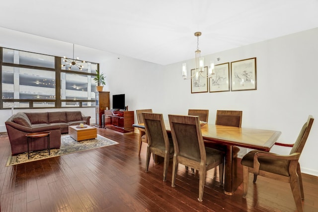 dining space featuring hardwood / wood-style flooring and an inviting chandelier