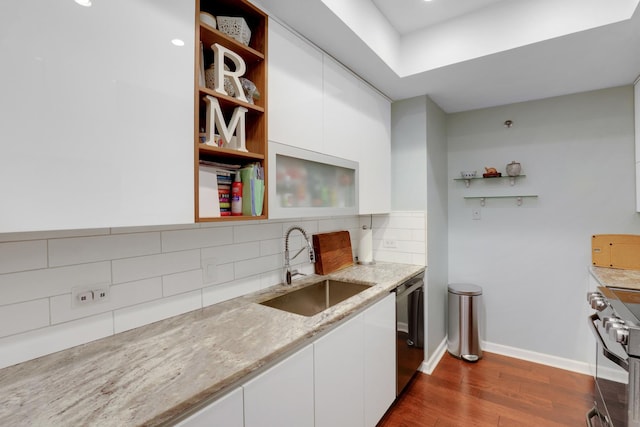 kitchen with white cabinetry, sink, tasteful backsplash, light stone counters, and appliances with stainless steel finishes