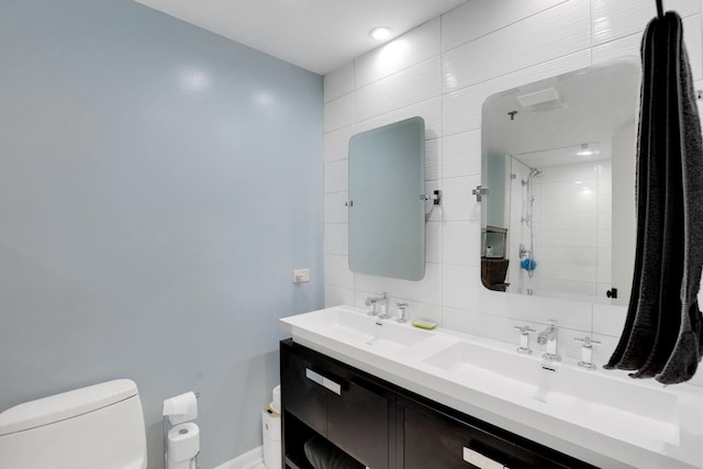 bathroom featuring tasteful backsplash, a shower, vanity, and toilet