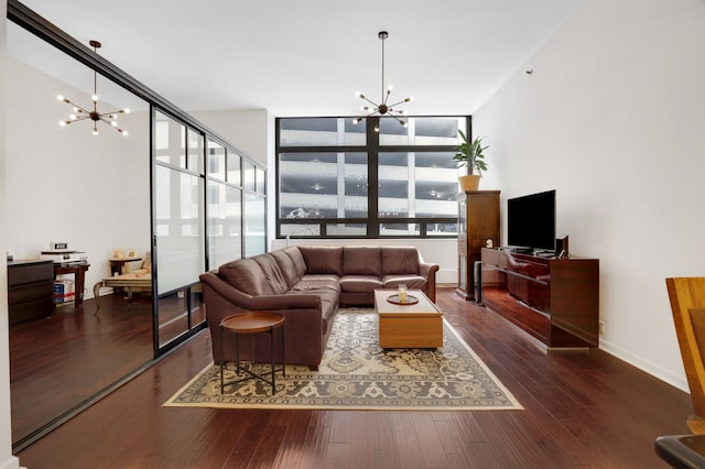 living room featuring dark hardwood / wood-style floors and an inviting chandelier