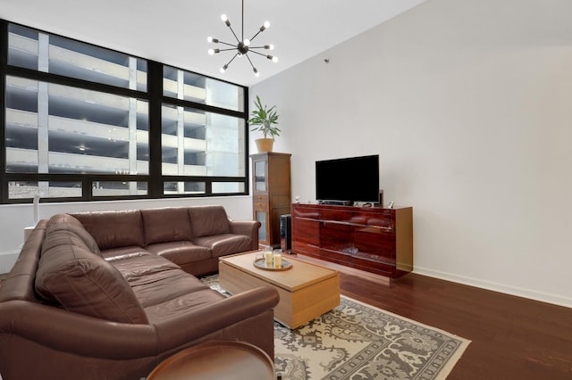 living room with hardwood / wood-style floors, a notable chandelier, and floor to ceiling windows