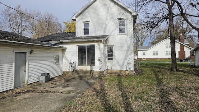 rear view of house with a yard