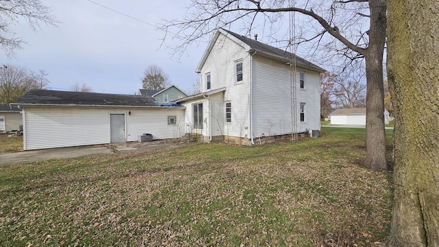 rear view of house with a yard and cooling unit