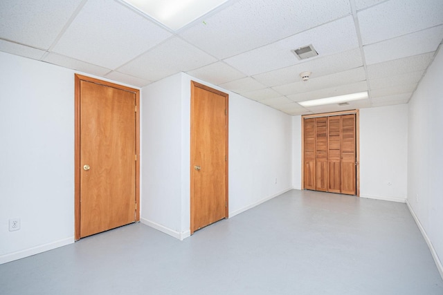 unfurnished room featuring a drop ceiling