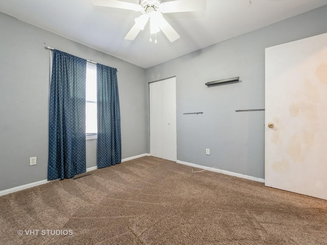 spare room featuring carpet flooring and ceiling fan