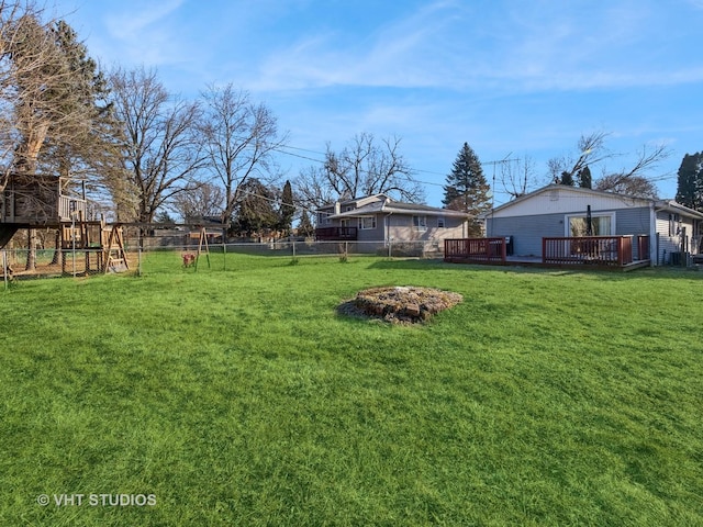 view of yard with a playground and a wooden deck