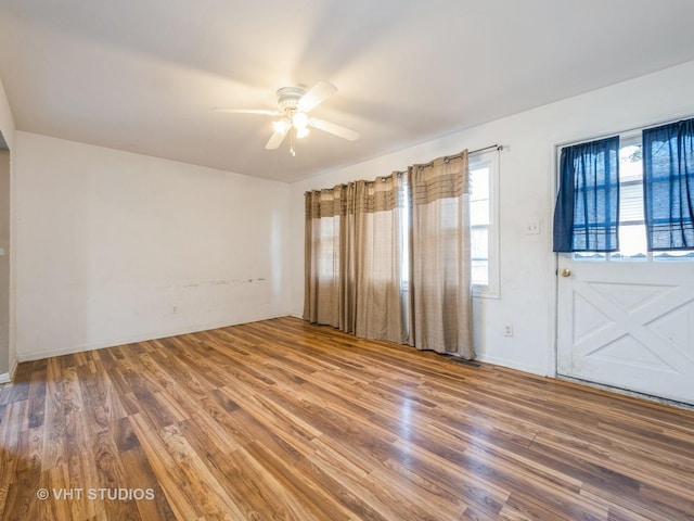 empty room featuring hardwood / wood-style flooring and ceiling fan