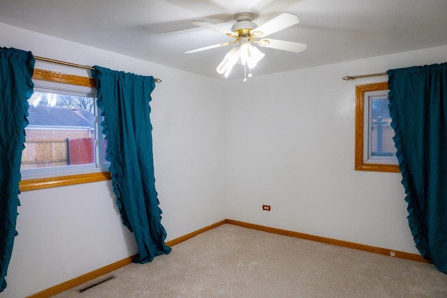 carpeted spare room with ceiling fan