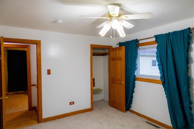 unfurnished bedroom featuring ceiling fan and light colored carpet